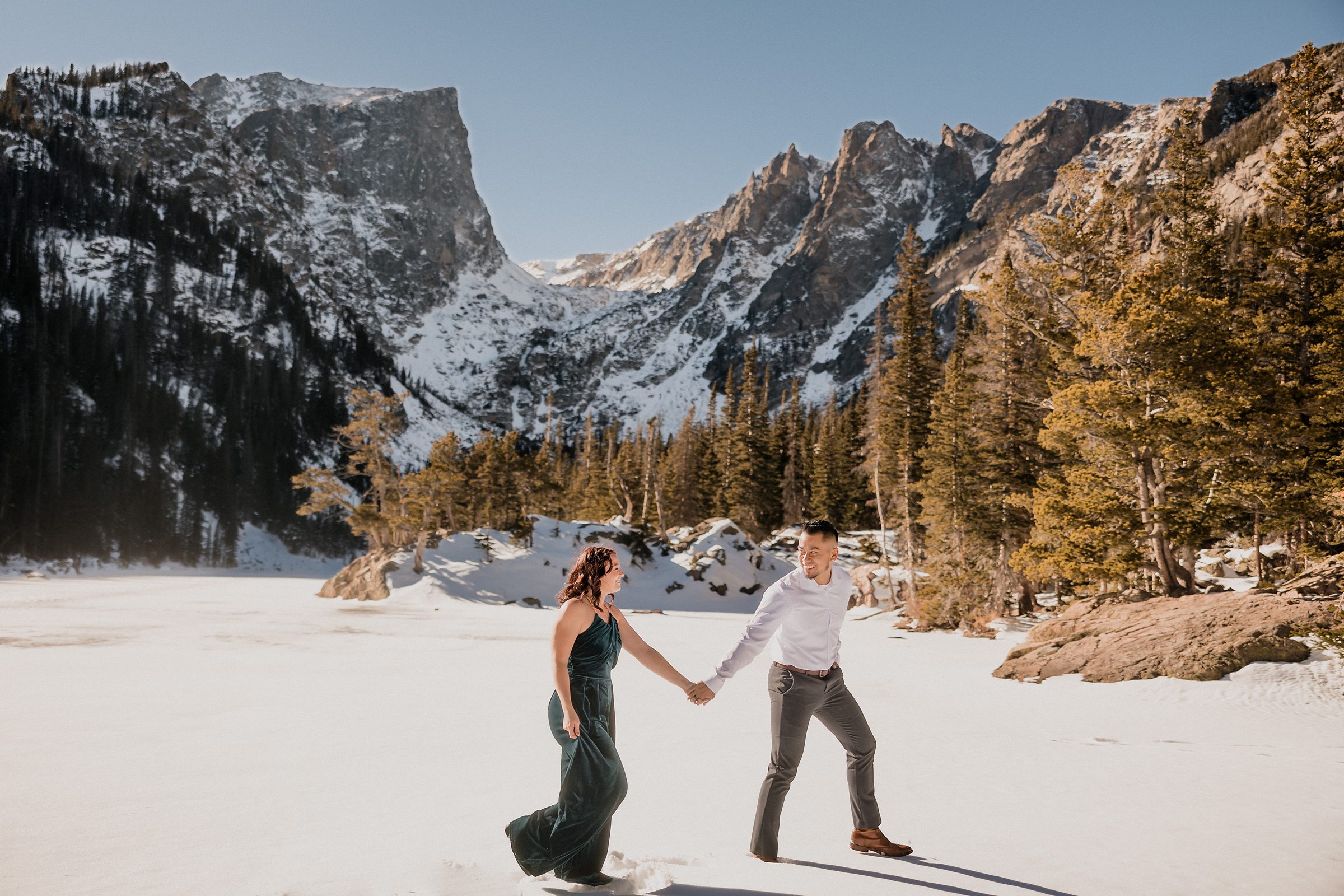 Couple walk during their Rocky Mountain National Park Engagement session