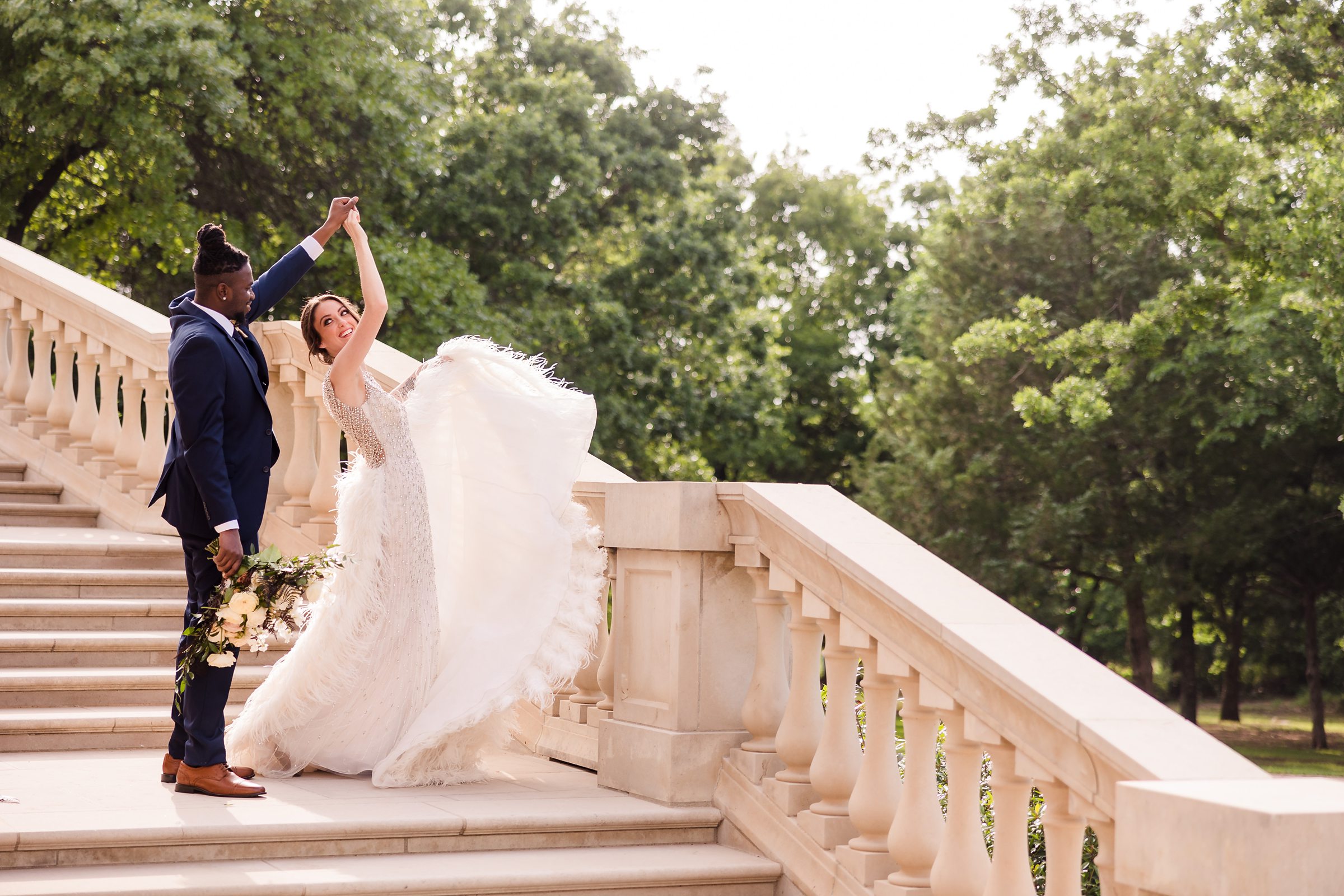 Groom twirls bride during a wedding at the Olana Wedding Venue in Hickory Creek, Texas.