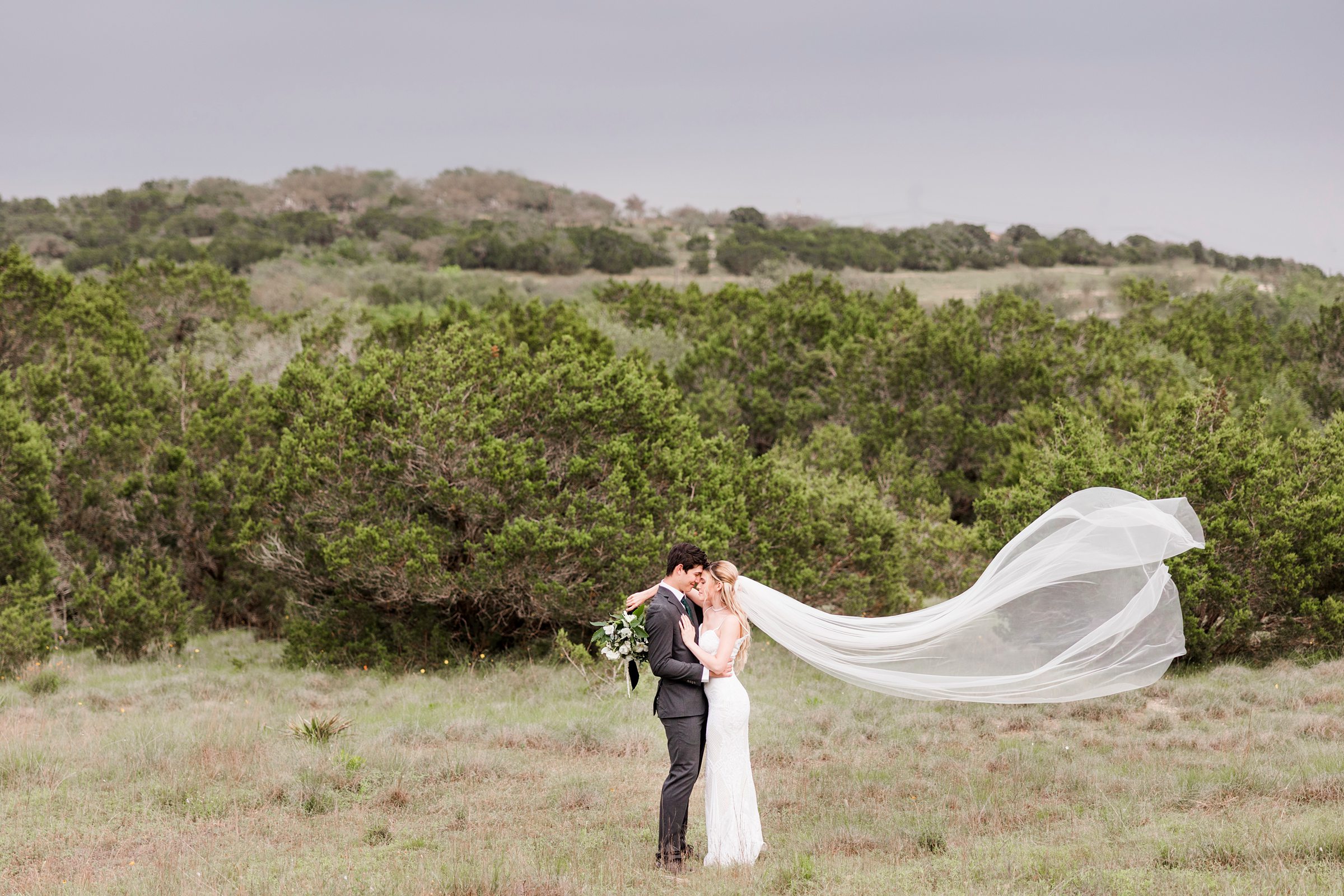 Bride and groom embrace during their wedding at the Terrace Club in Dripping Springs, Texas.