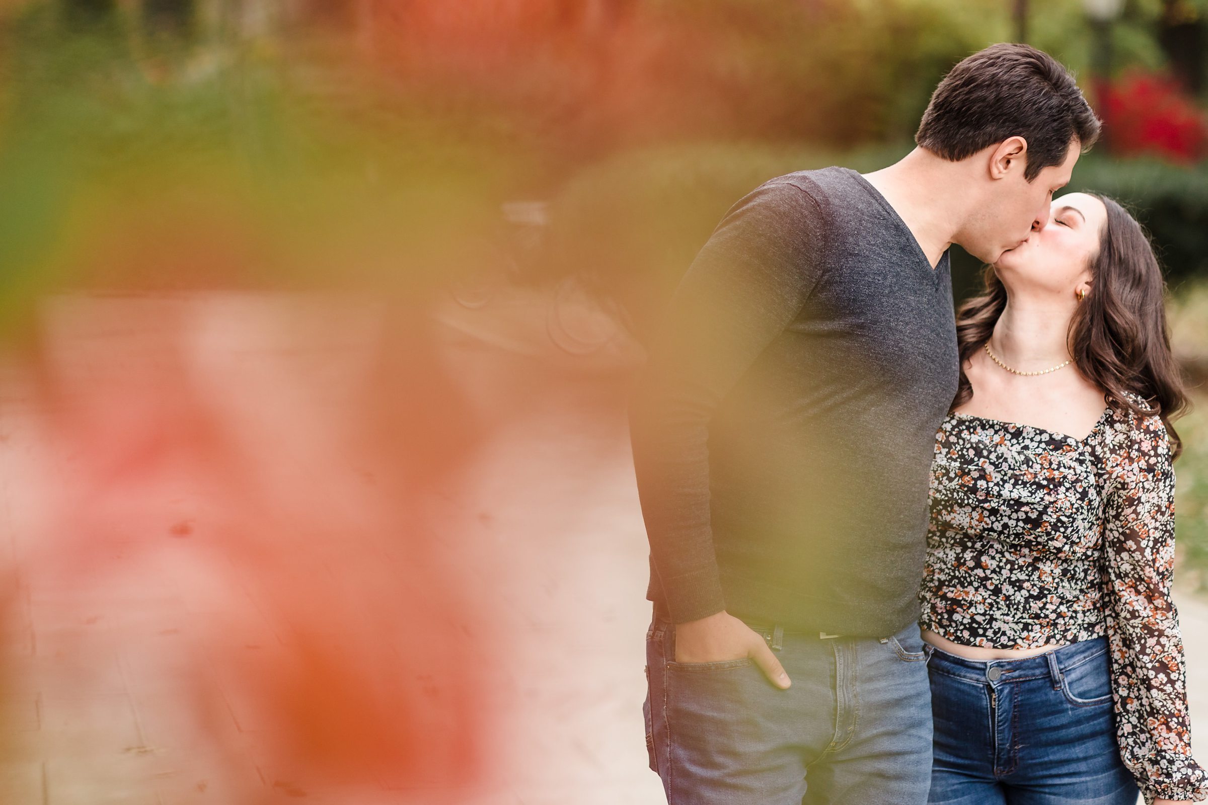 Couple kiss during their engagement session at the University of Chicago in Chicago, Illinois.