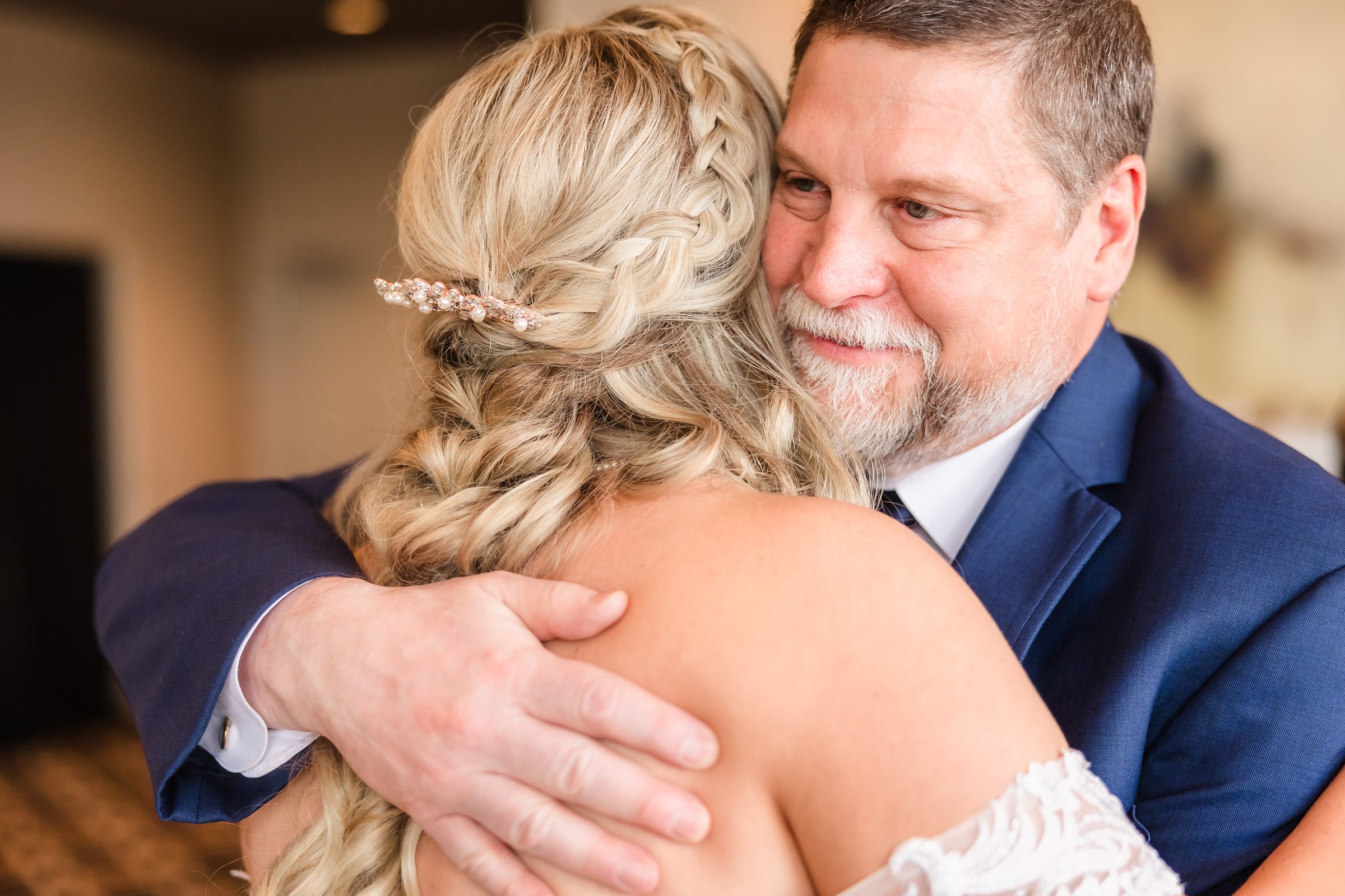 Dad hugs his daughter before her wedding at at the Warehouse on State in Peoria, Illinois