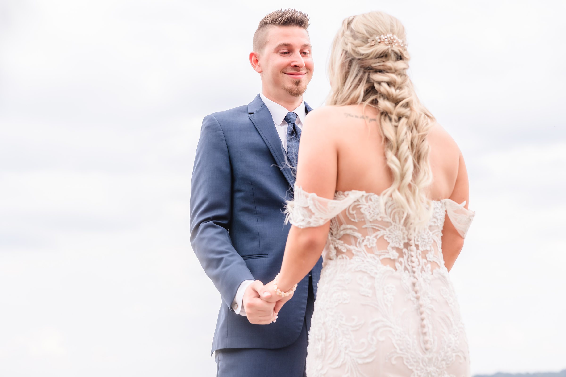 The groom sees his bride for the first time on the Peoria Riverfront in Illinois.