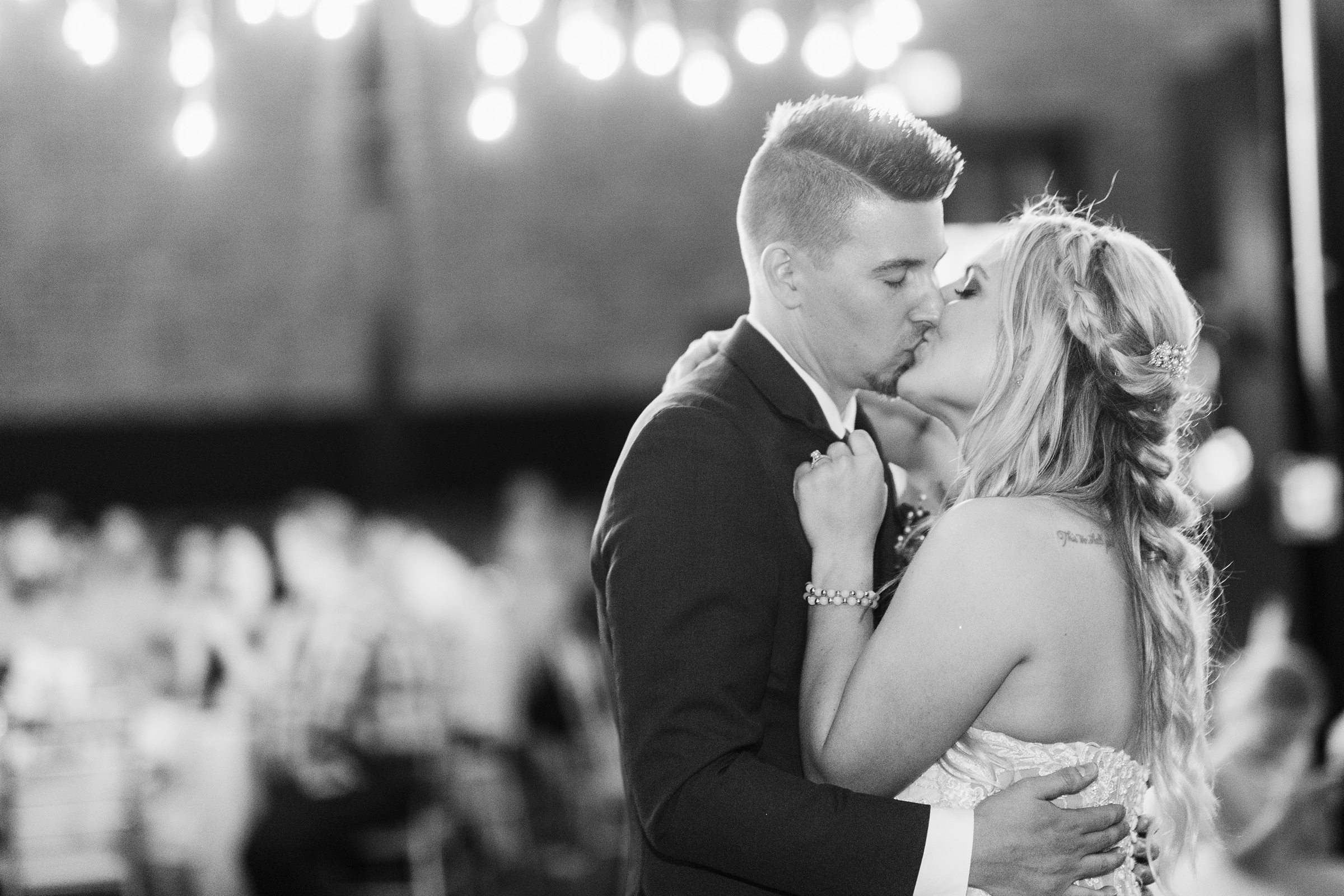 Bride and groom kiss after their first dance at the Warehouse on State in Peoria, Illinois