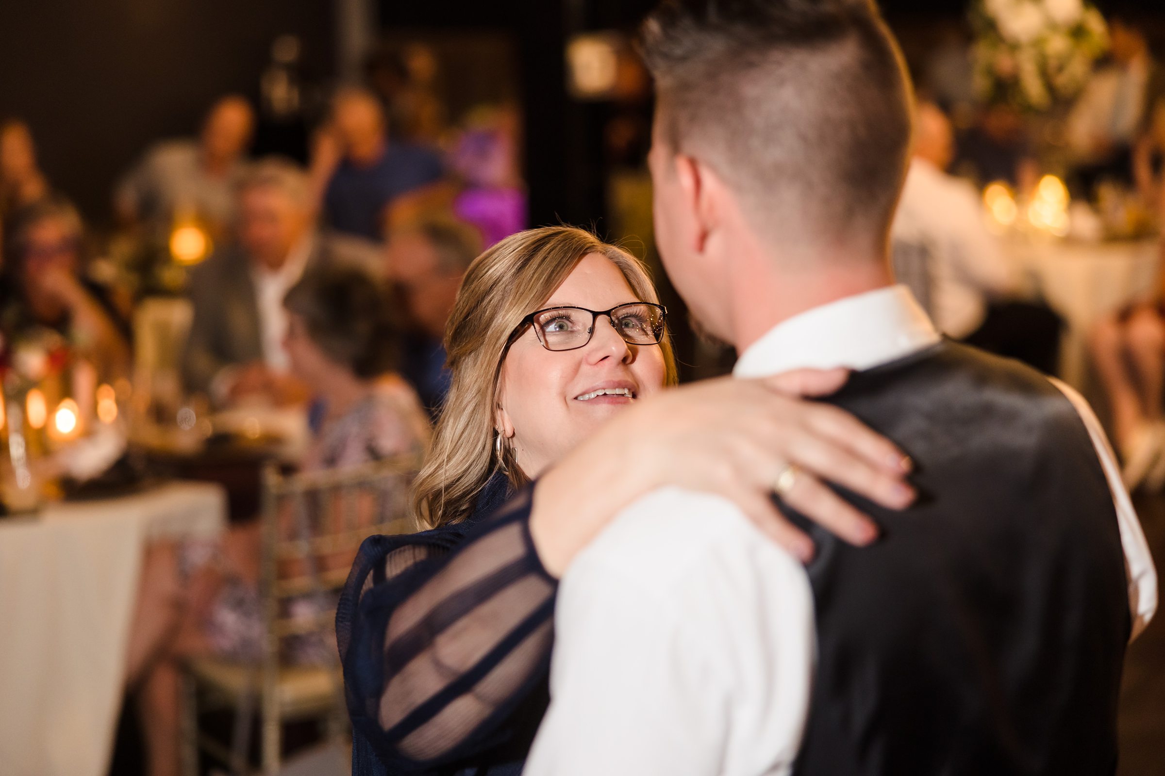 The groom dances with her son during his wedding at the Warehouse on State in Peoria, Illinois