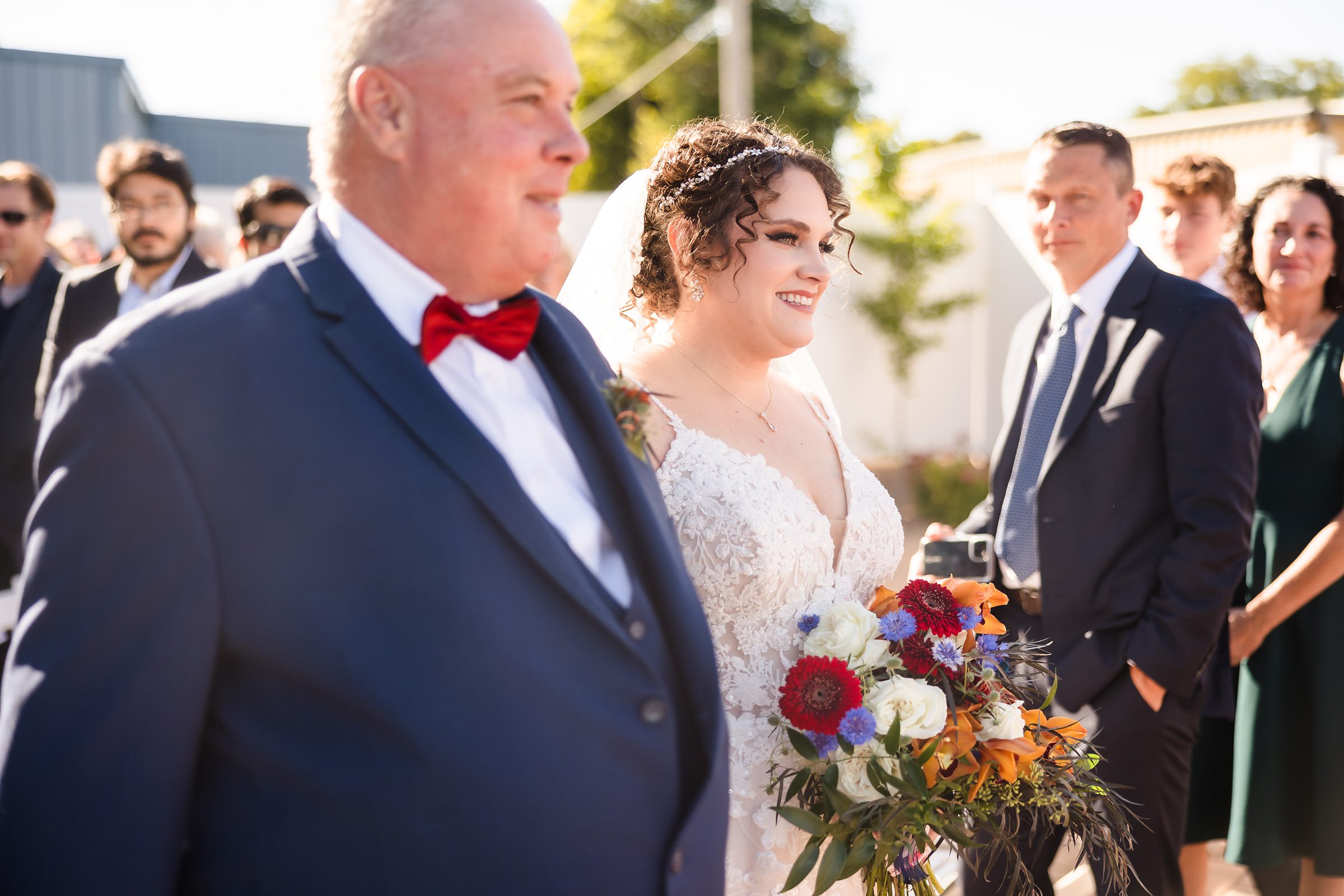 Bride and father walk down the aisle during a wedding at the Legacy Building in El Paso, Illinois.