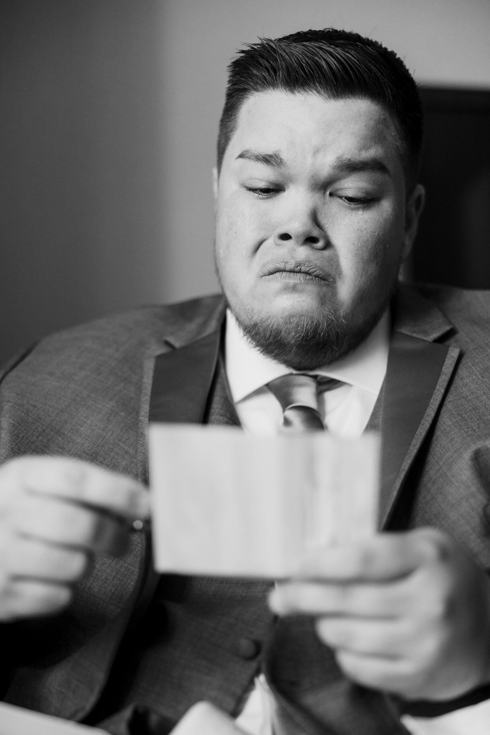 Groom gets emotional readying a letter before his wedding at the Destihl Brewery in Normal, Illinois.