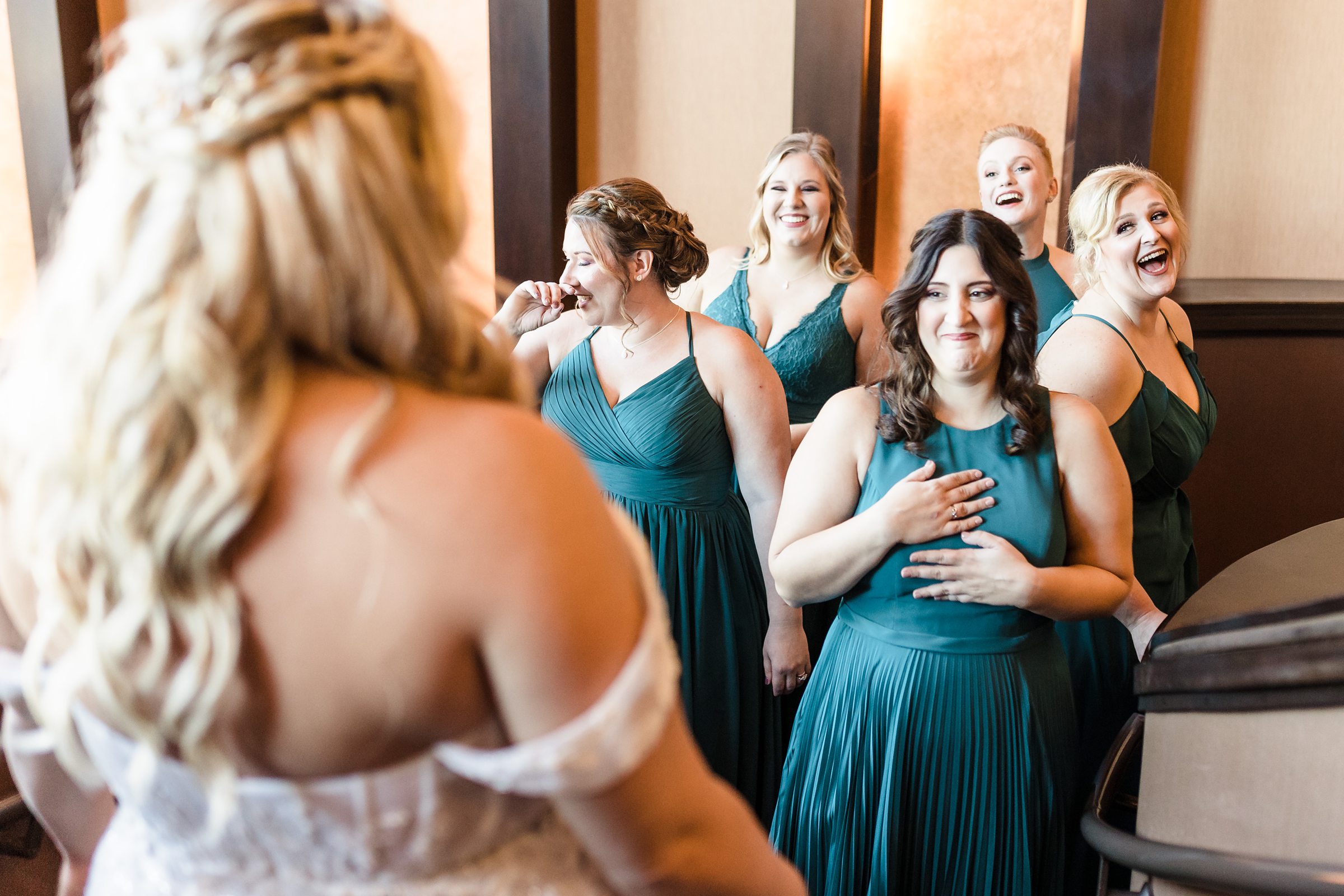 Bridesmaids see the bride for the first time before a wedding at the Destihl Brewery in Normal, Illinois.