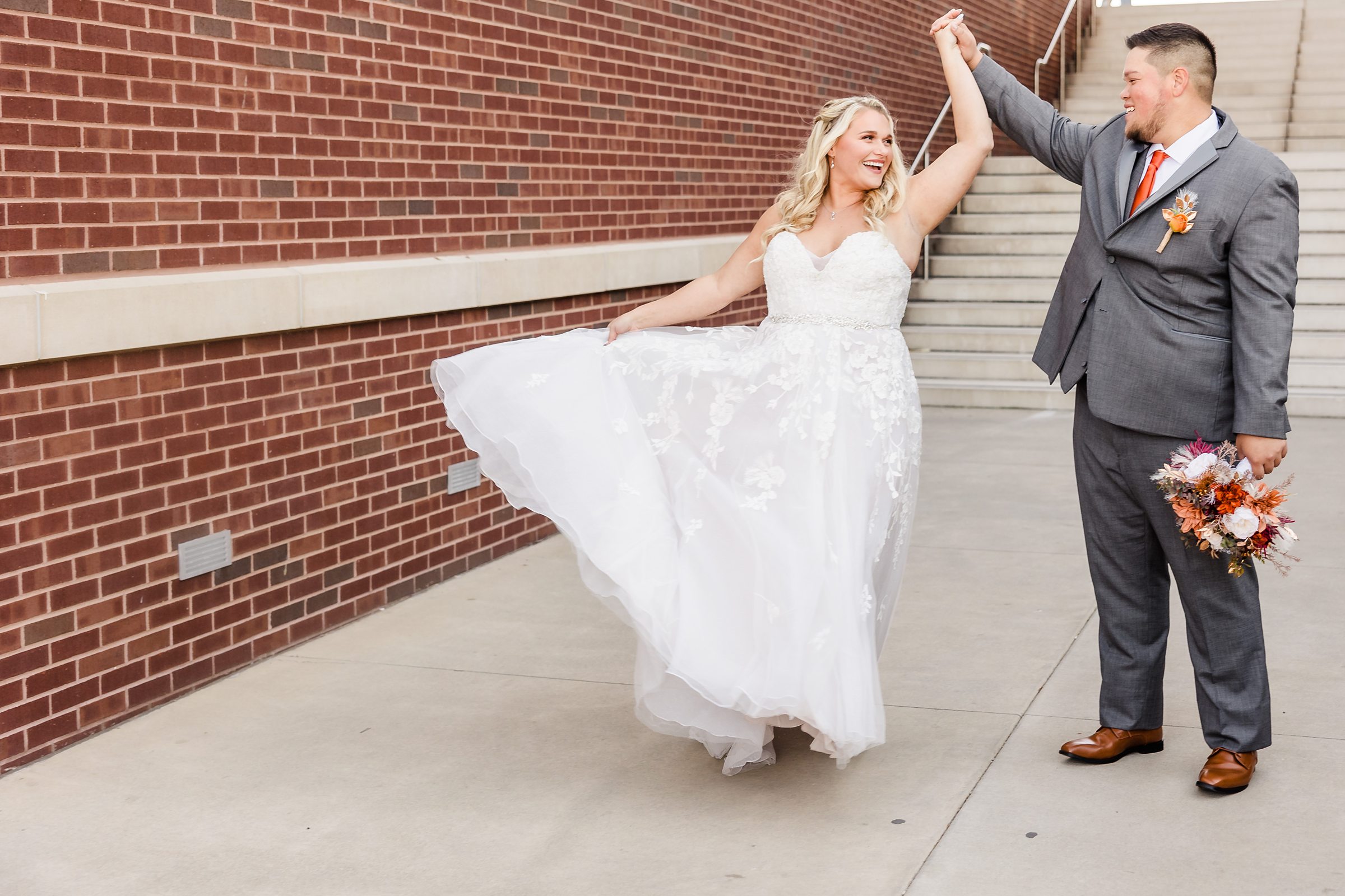 Bride and groom celebrate getting married during their wedding at the Destihl Brewery in Normal, Illinois.