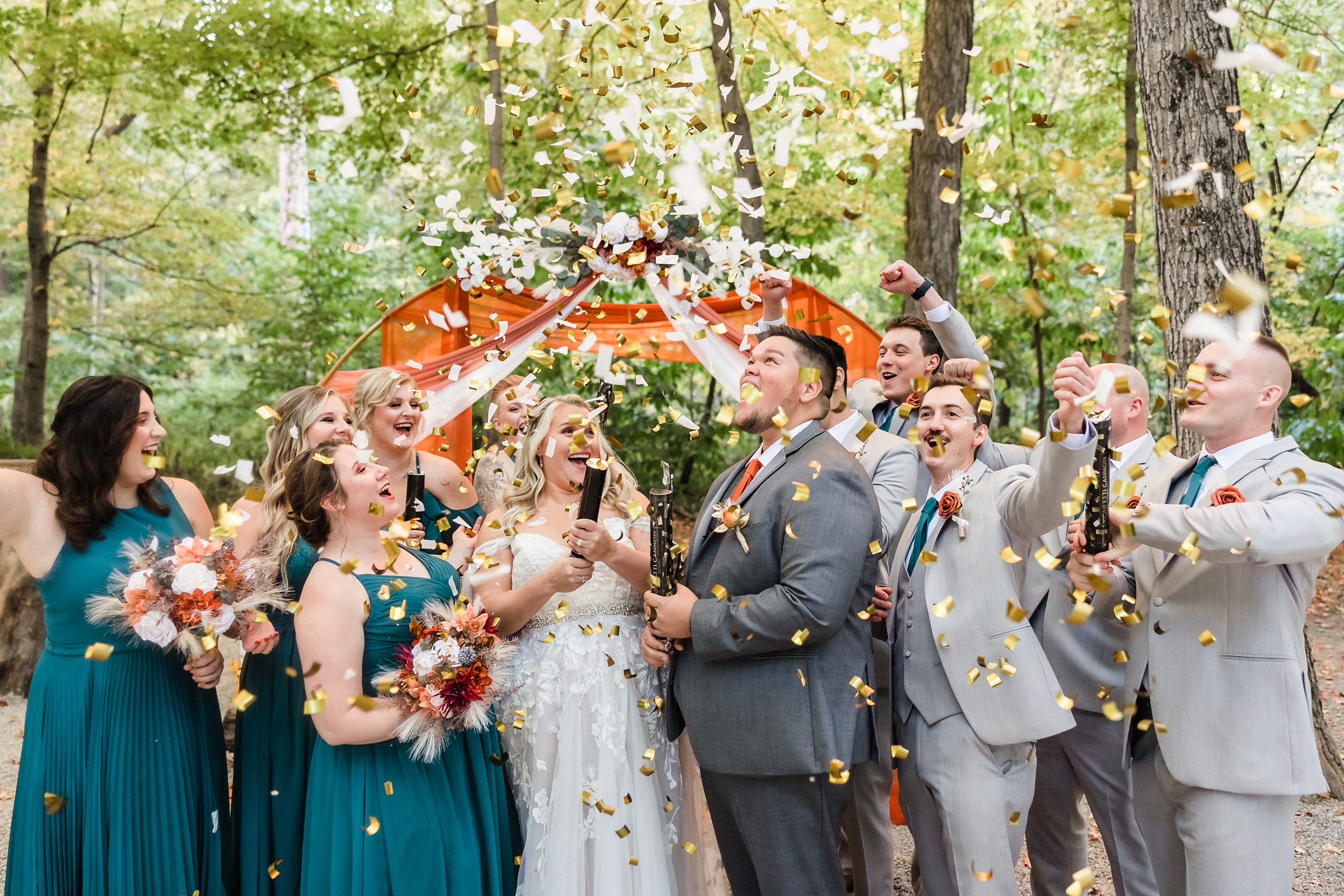 Bridal party celebrate during a wedding ceremony at Funks Grove in Mclean, Illinois.