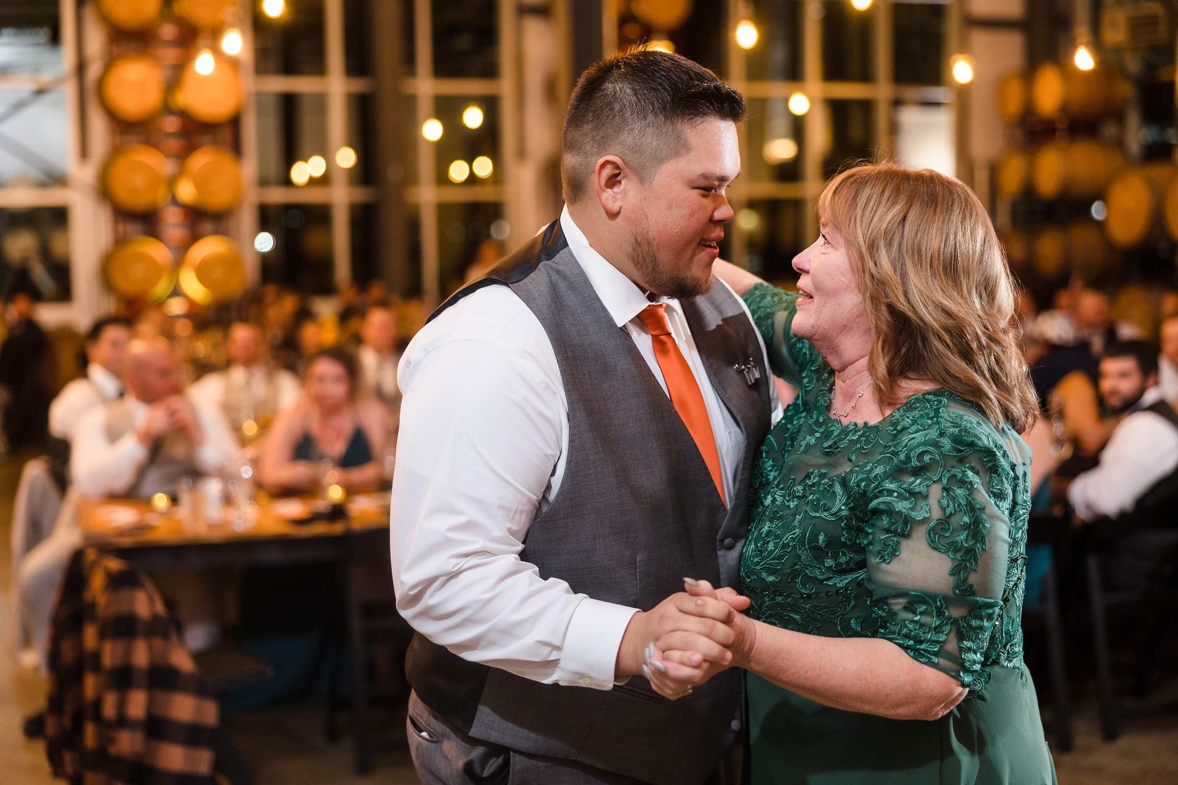 Groom dances with his mother during a wedding at the Destihl Brewery in Normal, Illinois