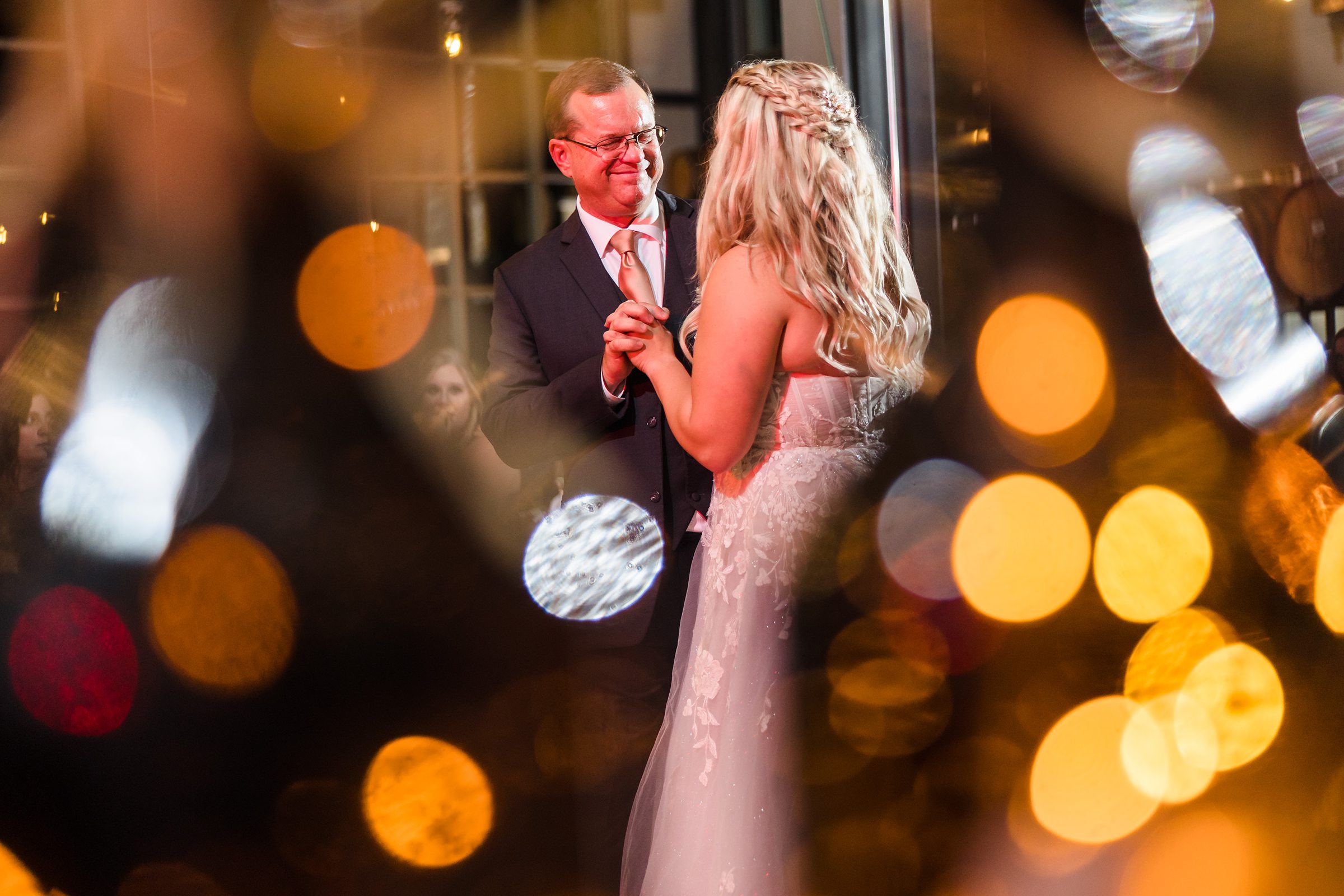 Bride dances with her father during a wedding at the Destihl Brewery in Normal, Illinois