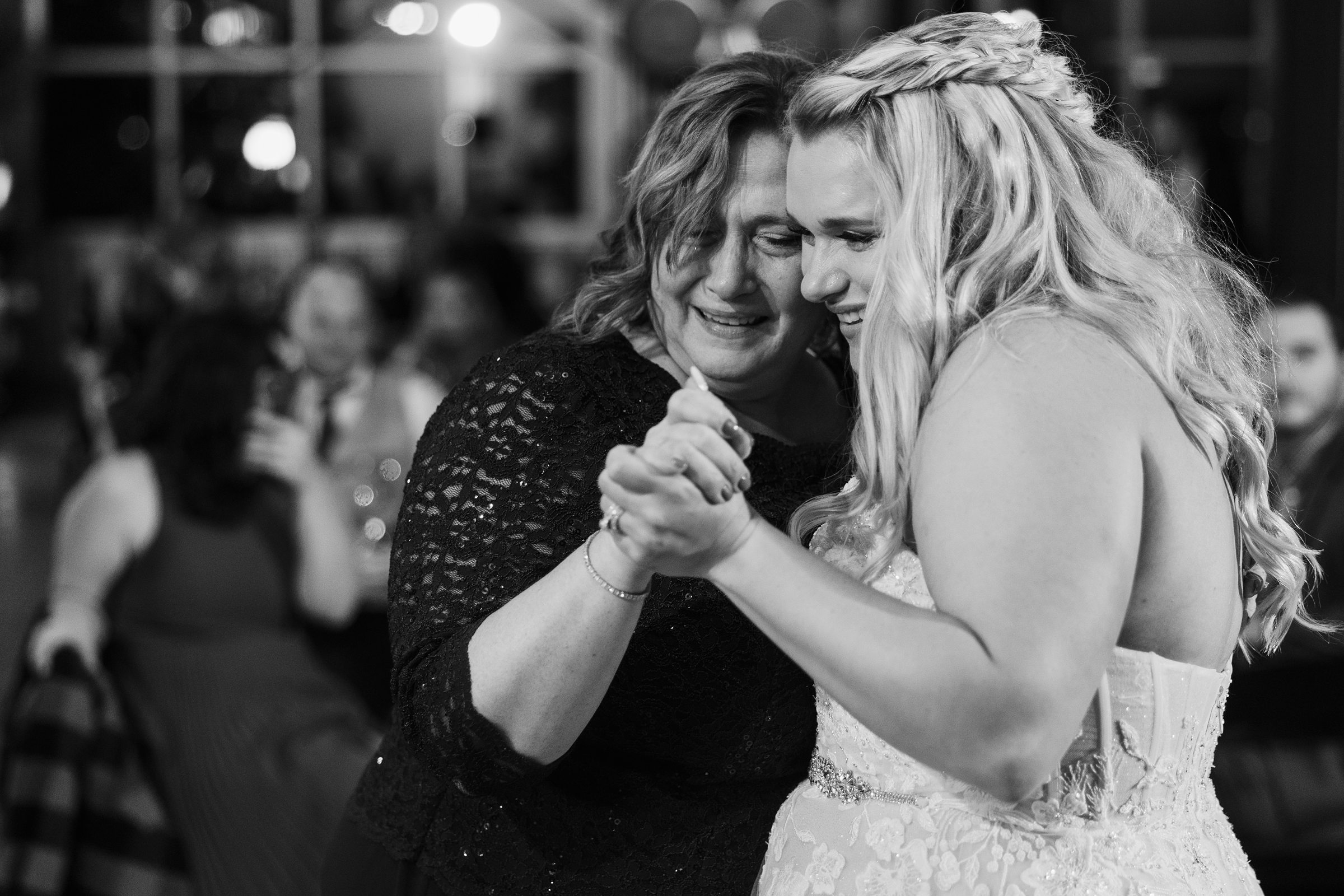 Bride and mother dance during a wedding at the Destihl Brewery in Normal, Illinois
