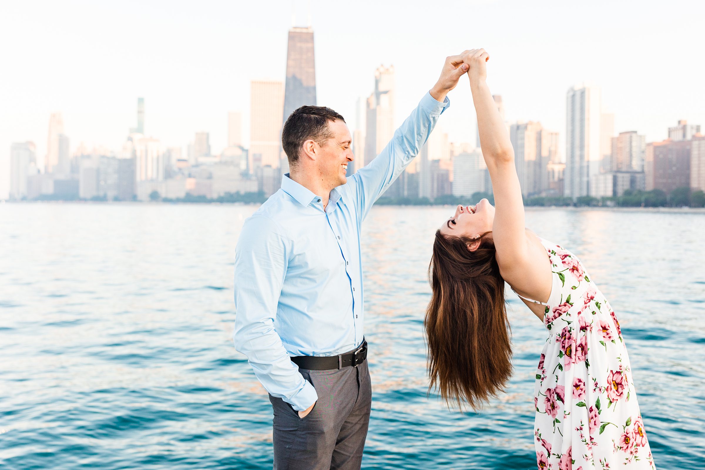 Couple celebrate their engagement at North Avenue Beach in Chicago, Illinois. Photograph taken by Illinois Wedding Photographers, Joanna and Brett Photography