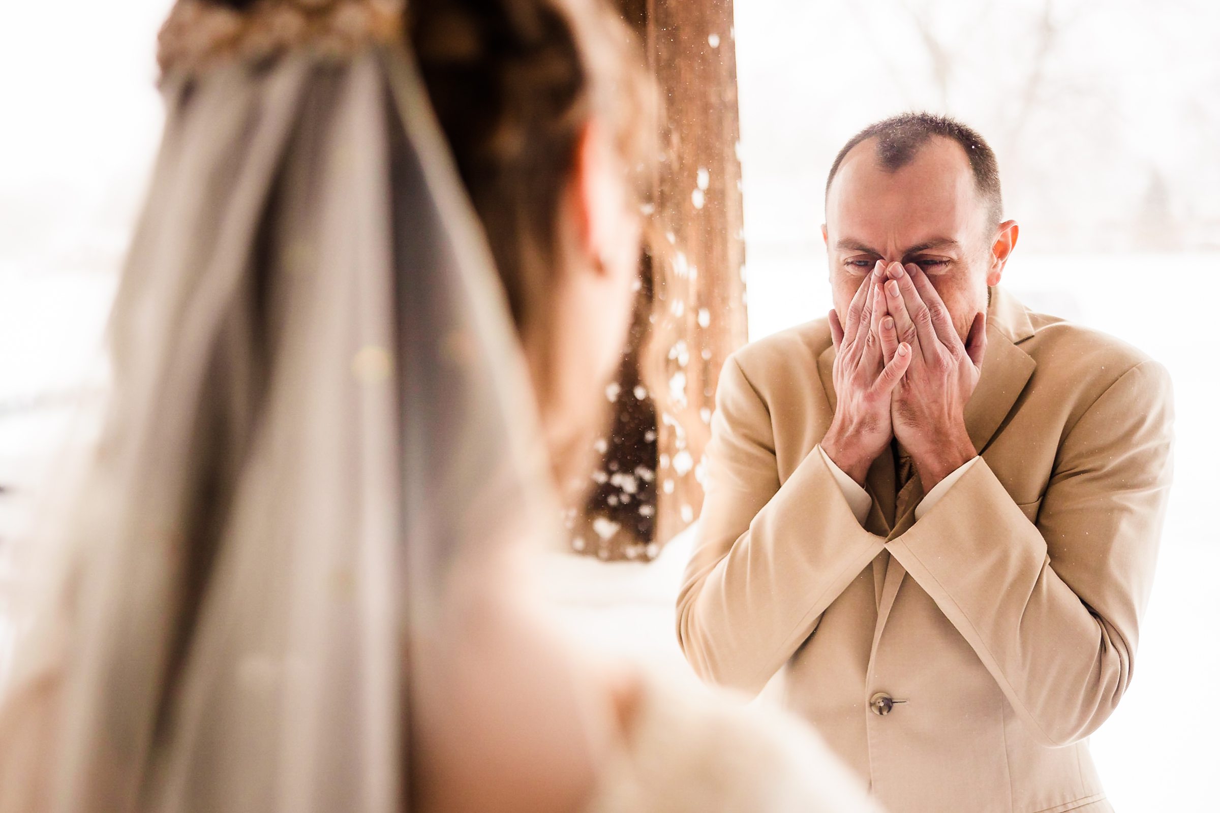Groom gets emotional seeing his bride during their wedding in Bloomington-Normal, Illinois.
