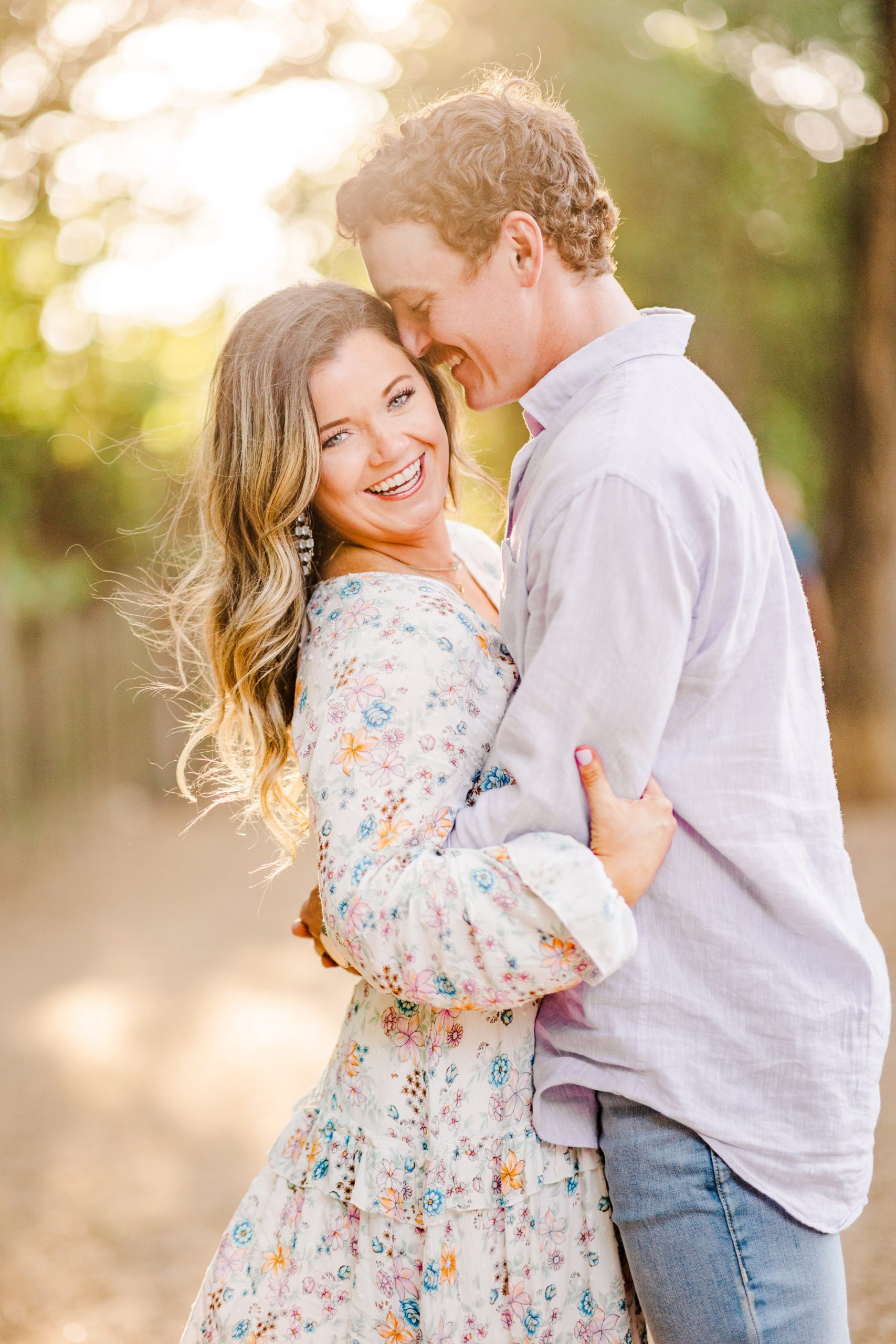 Couple embrace during their engagement session at Butler Park in Austin, Texas.