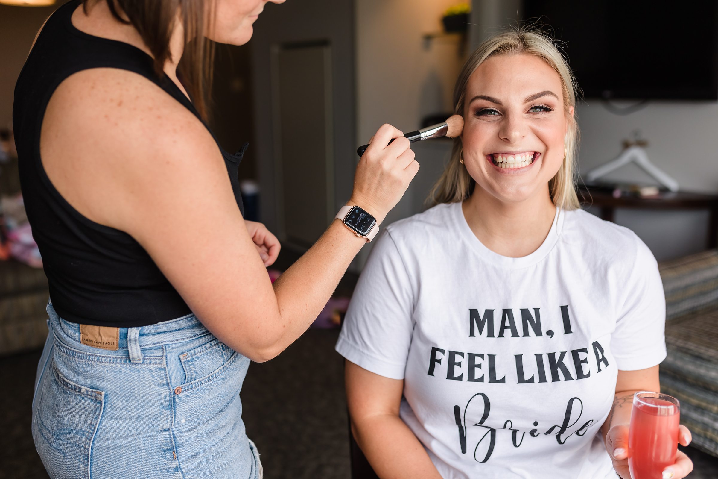 Bride gets her makeup done before her wedding at the Warehouse on State in Peoria, Illinois