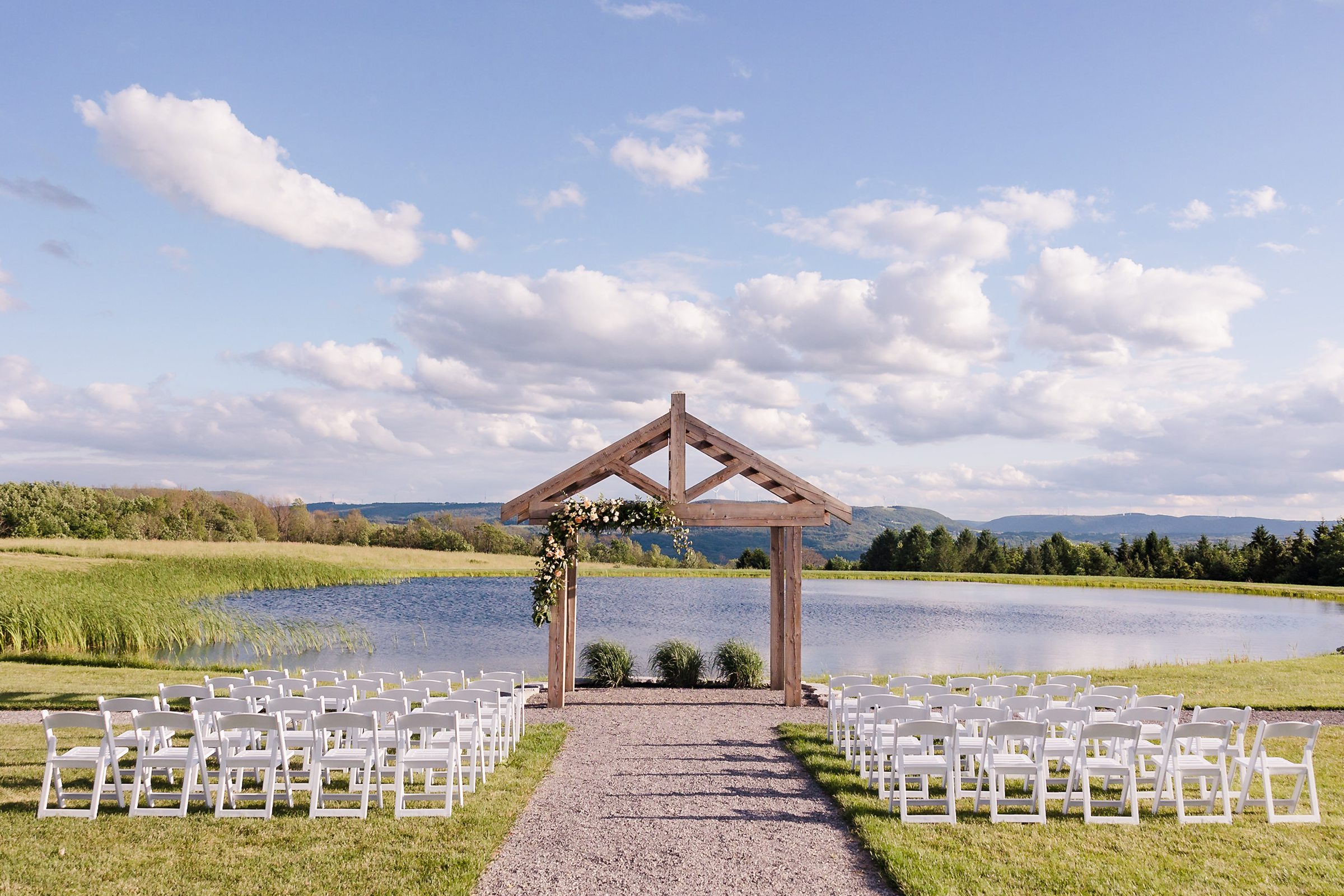 Outdoor ceremony setup at the Wren's Roost Barn Venue in Naples, New York.