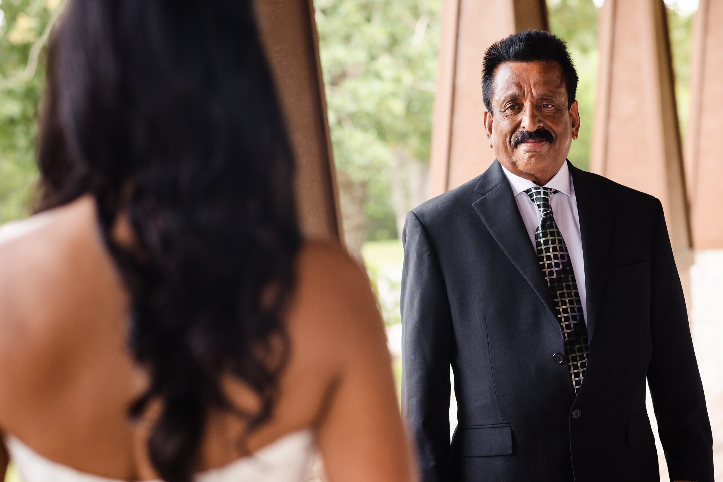 Dad sees his daughter for the first time during a wedding the Shiraz Garden Wedding Venue in Bastrop, Texas.