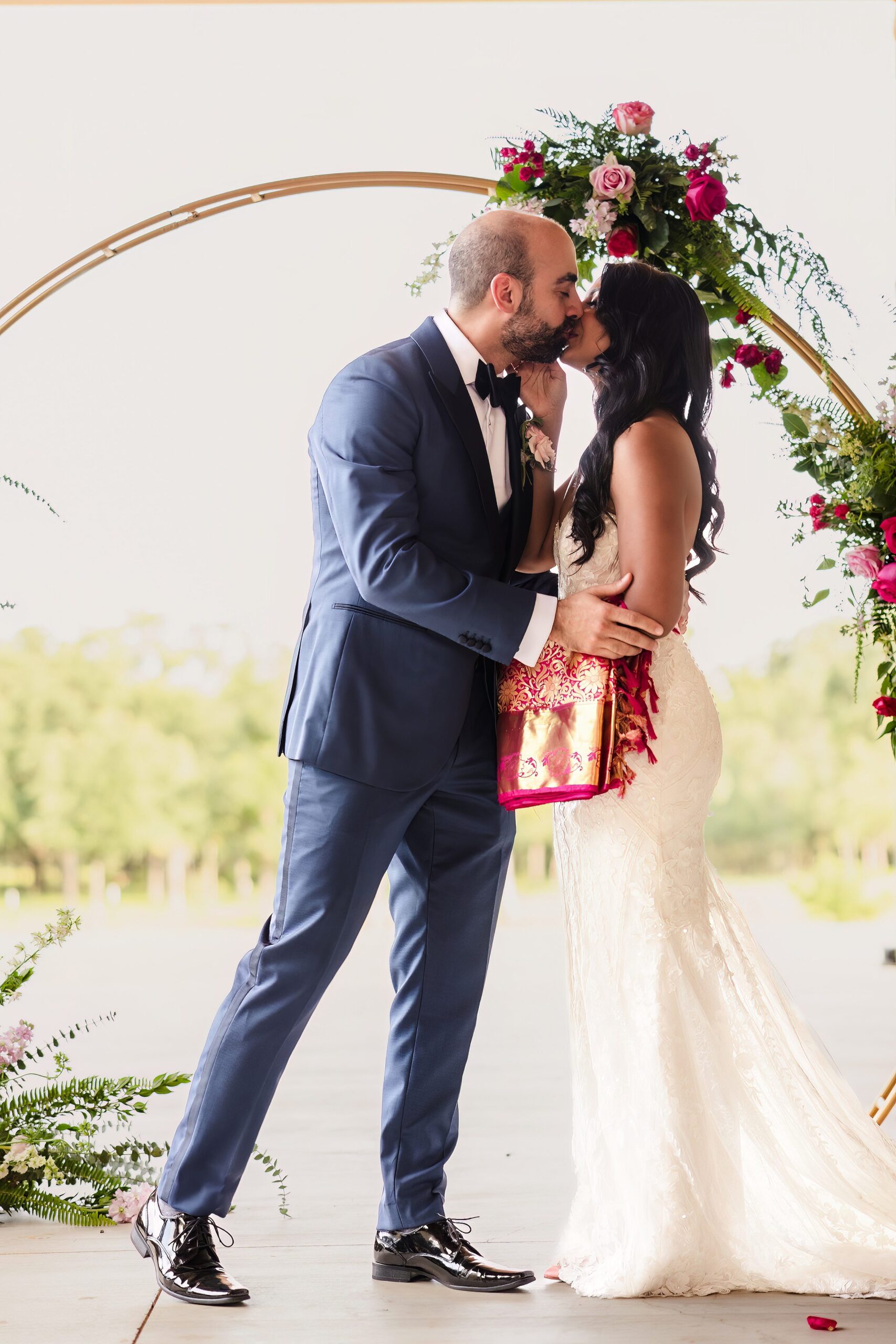 Couple share a first kiss during a wedding at Shiraz Garden in Bastrop, Texas.