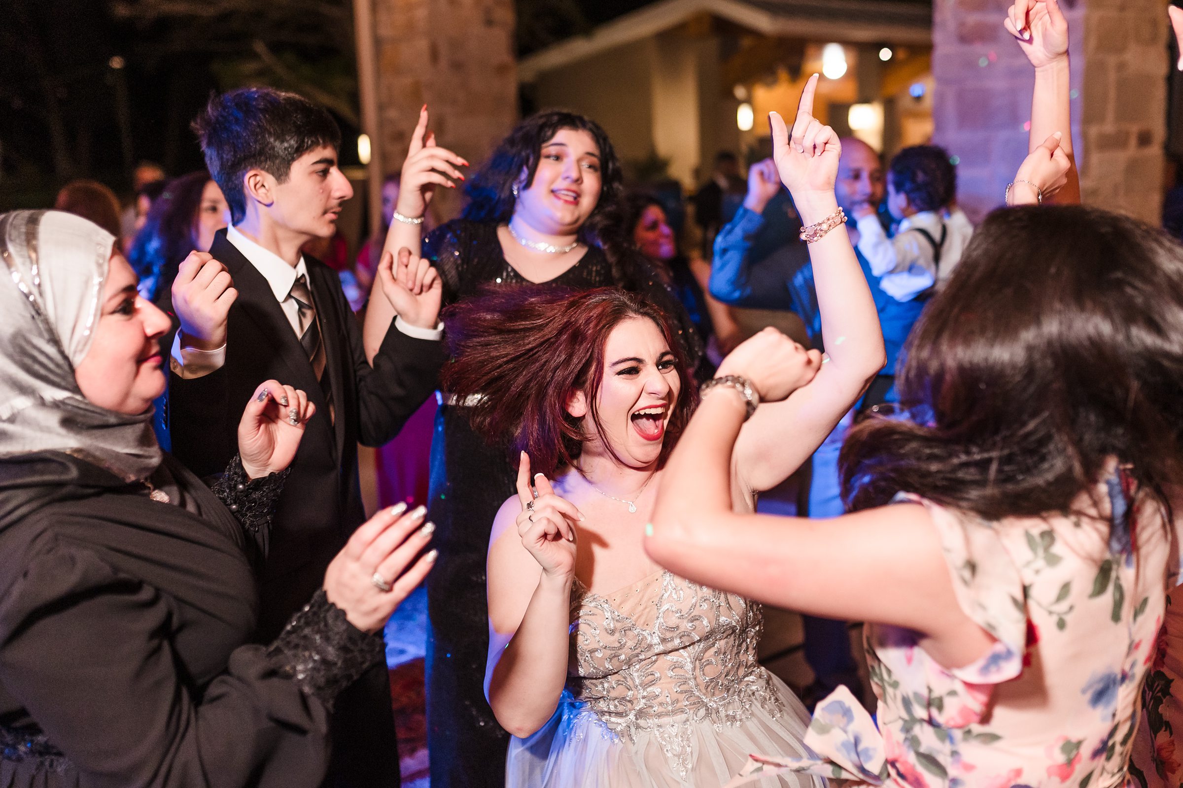 Guests dance on the dance floor during a wedding at Shiraz Garden in Bastrop, Texas.