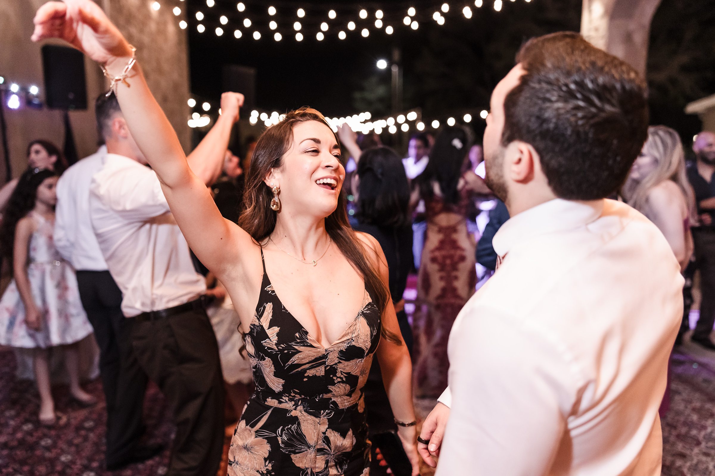 Guests dance on the dance floor during a wedding at Shiraz Garden in Bastrop, Texas.